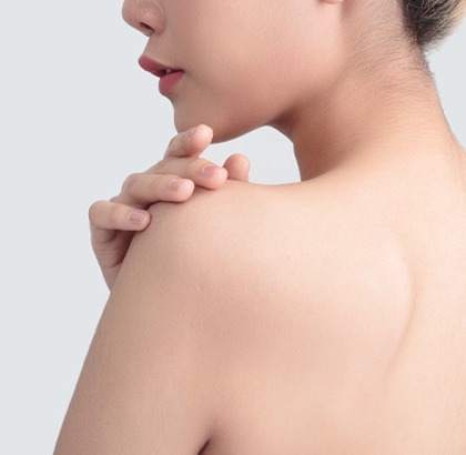 Woman's back with clean, smooth skin feeling shoulder